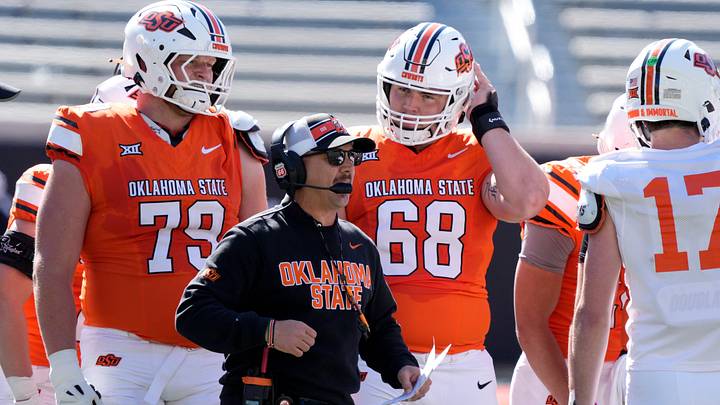 Oklahoma State coach Eric Morris talks wuth players in front of Jacob Sexton (79) and Joseph Hanson (79) during a spring football game for the Oklahoma State University Cowboys at Boone Pickens Stadium in Stillwater, Okla., Saturday, April 18, 2026.