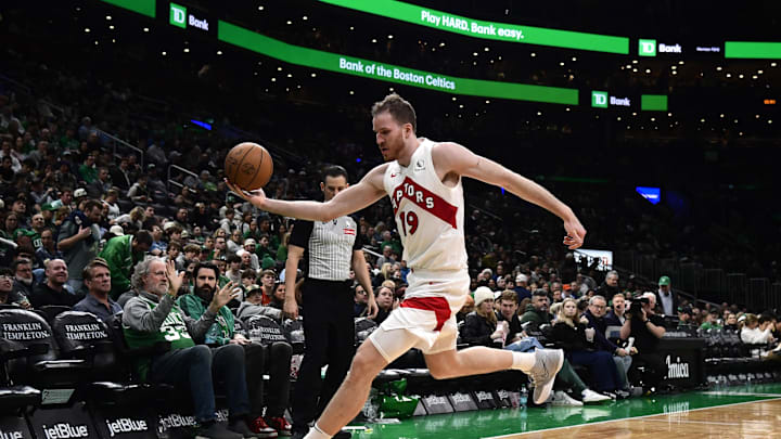 Dec 31, 2024; Boston, Massachusetts, USA;  Toronto Raptors center Jakob Poeltl (19) saves the ball from going out of bounds during the second half against the Boston Celtics at TD Garden. Mandatory Credit: Bob DeChiara-Imagn Images