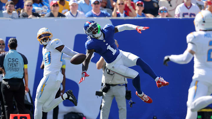 Sep 28, 2025; East Rutherford, New Jersey, USA; Los Angeles Chargers cornerback Cam Hart (20) breaks up a pass intended for New York Giants wide receiver Malik Nabers (1) during the second quarter at MetLife Stadium. Nabers was carted off the field with an injury after the play. Sep 28, 2025; East Rutherford, New Jersey, USA; Los Angeles Chargers cornerback Cam Hart (20) breaks up a pass intended for New York Giants wide receiver Malik Nabers (1) during the second quarter at MetLife Stadium. Nabers was carted off the field with an injury after the play.