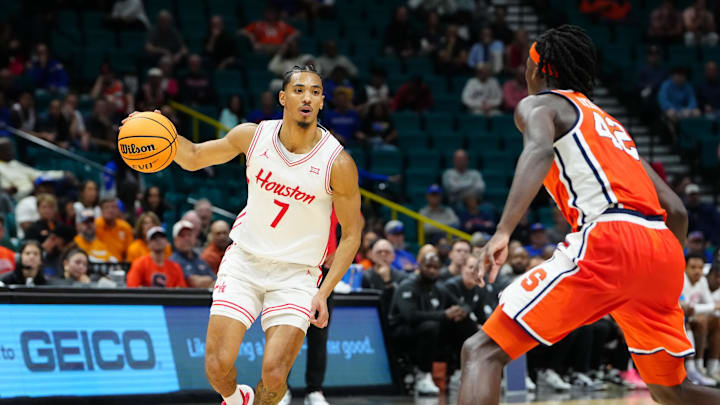 Nov 24, 2025; Las Vegas, Nevada, USA; Houston Cougars guard Milos Uzan (7) drives to the hoop past Syracuse Orange forward William Kyle III (42) during the first half of a 2025 Players Era Festival group play game at MGM Grand Garden Arena. Mandatory Credit: Stephen R. Sylvanie-Imagn Images
