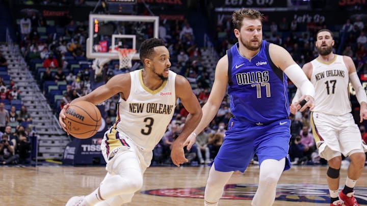 Feb 17, 2022; New Orleans, Louisiana, USA;  New Orleans Pelicans guard CJ McCollum (3) dribbles against Dallas Mavericks guard Luka Doncic (77) during the second half at the Smoothie King Center. Mandatory Credit: Stephen Lew-Imagn Images