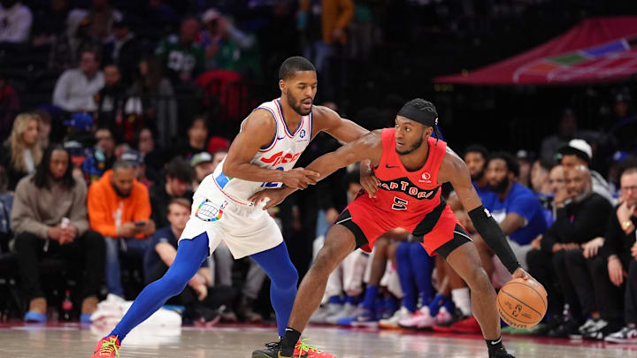 Feb 11, 2025; Philadelphia, Pennsylvania, USA; Toronto Raptors guard Immanuel Quickley (5) controls the ball against Philadelphia 76ers guard Jared Butler (12) in the second quarter at Wells Fargo Center. Mandatory Credit: Kyle Ross-Imagn Images