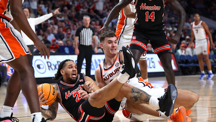 Nov 16, 2025; Birmingham, Alabama, USA; Auburn Tigers forward Filip Jovic (38) and Houston Cougars guard Emanuel Sharp (21) scramble for the loose ball during the first half at Legacy Arena at BJCC. Mandatory Credit: David Leong-Imagn Images