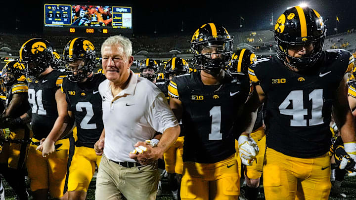 Iowa Hawkeyes head coach Kirk Ferentz runs off the field with his players after becoming the winningest coach in Big Ten history, passing Woody Hayes, with a win over the Massachusetts Minutemen Sept. 13, 2025 at Kinnick Stadium in Iowa City, Iowa.