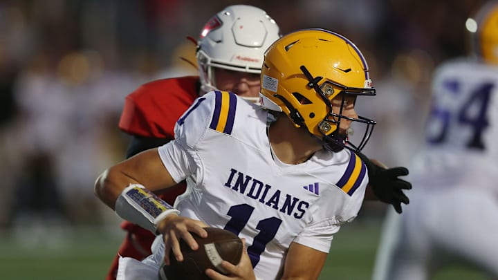 Indianola's quarterback Asher Brueck (11) runs with the ball against Ballard earlier this season. The Indians will look to pull and upset this week at ADM.