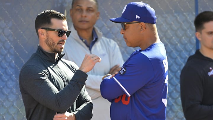 Dodgers Executive Vice President and General Manager Brandon Gomes talks with manager Dave Roberts (30) during spring training at Camelback Ranch on Feb. 18.