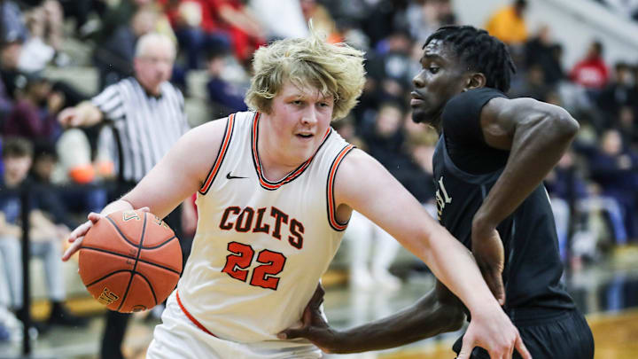 DeSale's William Gibson (22) drives on Little Rock Central's Annor Boateng (12) at Thursday's 2023 Chad Gardner Law King of the Bluegrass holiday basketball tournament at Fairdale High School. Dec. 21, 2023