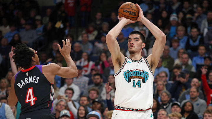 Dec 26, 2024; Memphis, Tennessee, USA; Memphis Grizzlies center Zach Edey (14) shoots for three during the first quarter against the Toronto Raptors at FedExForum. Mandatory Credit: Petre Thomas-Imagn Images