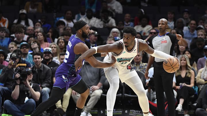 Apr 8, 2025; Charlotte, North Carolina, USA;  Memphis Grizzlies center Jaren Jackson Jr. (13) looks to drive past Charlotte Hornets guard Josh Okogie (12) during the first half at the Spectrum Center. Mandatory Credit: Sam Sharpe-Imagn Images