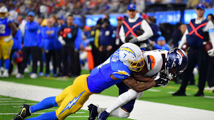 Dec 19, 2024; Inglewood, California, USA; Denver Broncos wide receiver Marvin Mims Jr. (19) runs the ball against Los Angeles Chargers cornerback Kristian Fulton (7) during the first half at SoFi Stadium. Mandatory Credit: Gary A. Vasquez-Imagn Images
