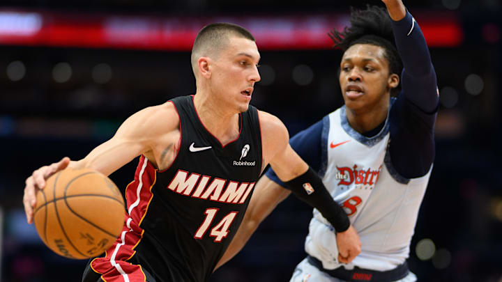 Mar 31, 2025; Washington, District of Columbia, USA; Miami Heat guard Tyler Herro (14) handles the ball against Washington Wizards guard Bub Carrington (8) during the second quarter at Capital One Arena. Mandatory Credit: Reggie Hildred-Imagn Images