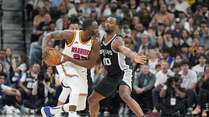Nov 23, 2024; San Antonio, Texas, USA;  Golden State Warriors forward Draymond Green (23) looks to pass in front of San Antonio Spurs forward Harrison Barnes (40) in the second half at Frost Bank Center. 