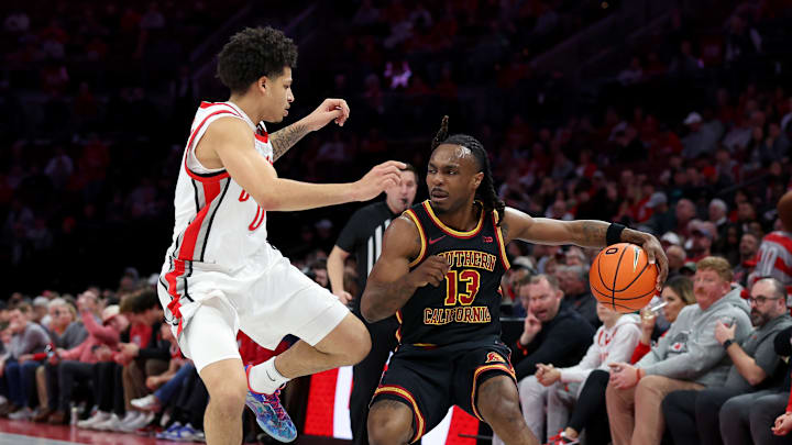 Feb 11, 2026; Columbus, Ohio, USA;  USC Trojans guard Kam Woods (13) controls the ball as Ohio State Buckeyes guard John Mobley Jr. (0) defends during the first half at Value City Arena. Mandatory Credit: Joseph Maiorana-Imagn Images