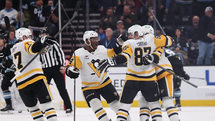 Jan 29, 2025; Salt Lake City, Utah, USA; Pittsburgh Penguins center Sidney Crosby (87) celebrates with teammates after scoring the winning goal against the Utah Hockey Club during overtime at Delta Center. Mandatory Credit: Rob Gray-Imagn Images