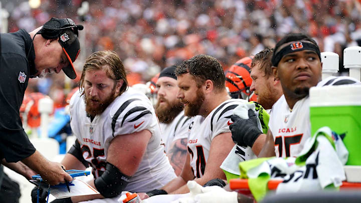 Cincinnati Bengals offensive line coach Frank Pollack, left, talks with Cincinnati Bengals guard Alex Cappa (65), Cincinnati Bengals guard Max Scharping (74) and Cincinnati Bengals guard Cordell Volson (67) in the fourth quarter of an NFL football game between the Cincinnati Bengals and Cleveland Browns, Sunday, Sept. 10, 2023, at Cleveland Browns Stadium in Cleveland.