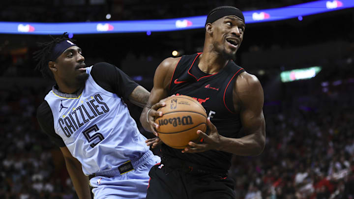 Jan 24, 2024; Miami, Florida, USA; Miami Heat forward Jimmy Butler (22) drives to the basket against Memphis Grizzlies guard Vince Williams Jr. (5) during the second quarter at Kaseya Center. Mandatory Credit: Sam Navarro-Imagn Images