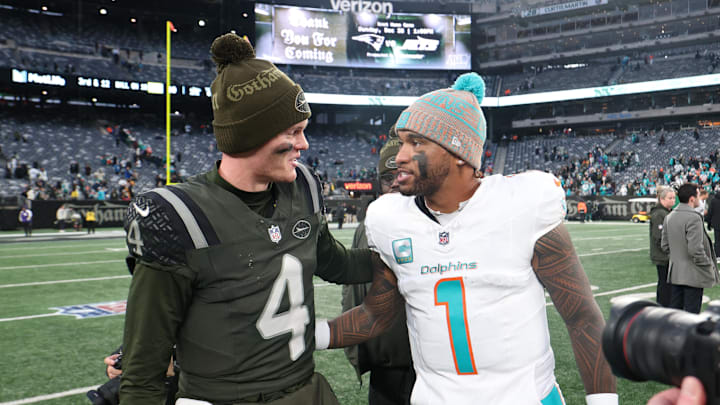 Dec 7, 2025; East Rutherford, New Jersey, USA; New York Jets quarterback Brady Cook (4) greets Miami Dolphins quarterback Tua Tagovailoa (1) after the game at MetLife Stadium. Mandatory Credit: Vincent Carchietta-Imagn Images