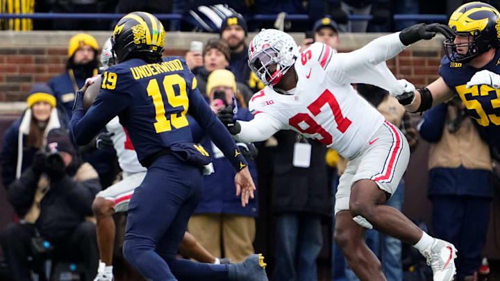 Ohio State Buckeyes defensive end Kenyatta Jackson Jr. (97) pursues Michigan Wolverines quarterback Bryce Underwood (19) during the NCAA football game at Michigan Stadium in Ann Arbor, Mich. on Nov. 29, 2025. Ohio State won 27-9.