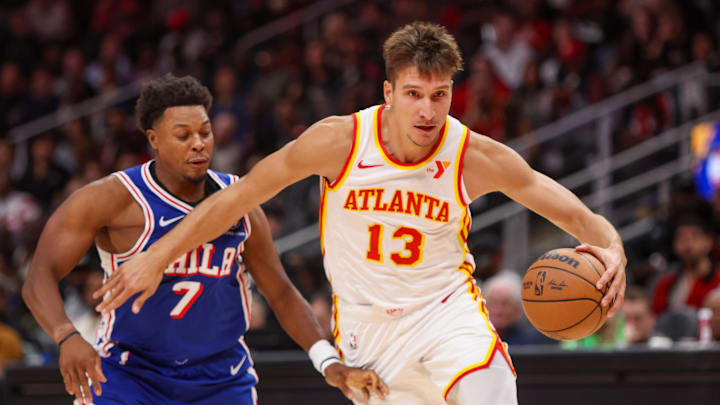 Oct 14, 2024; Atlanta, Georgia, USA; Atlanta Hawks guard Bogdan Bogdanovic (13) drives past Philadelphia 76ers guard Kyle Lowry (7) in the third quarter at State Farm Arena. Mandatory Credit: Brett Davis-Imagn Images