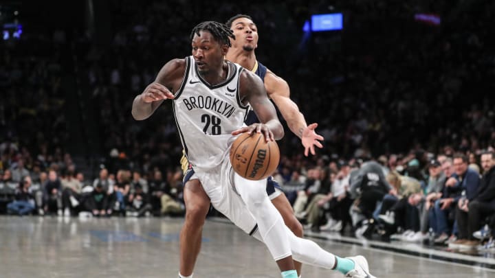 Mar 19, 2024; Brooklyn, New York, USA;  Brooklyn Nets forward Dorian Finney-Smith (28) drives past New Orleans Pelicans guard Trey Murphy III (25) in the third quarter at Barclays Center. Mandatory Credit: Wendell Cruz-USA TODAY Sports