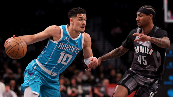 Feb 10, 2025; Brooklyn, New York, USA; Charlotte Hornets guard Josh Green (10) drives to the basket against Brooklyn Nets guard Keon Johnson (45) during the first quarter at Barclays Center. Mandatory Credit: Brad Penner-Imagn Images