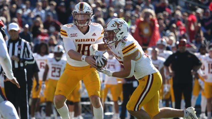 Nov 18, 2023; Oxford, Mississippi, USA; Louisiana Monroe Warhawks quarterback Jiya Wright (18) hands the ball off to running back Bennett Galloway (26) during the first half against the Mississippi Rebels at Vaught-Hemingway Stadium. Mandatory Credit: Petre Thomas-USA TODAY Sports Nov 18, 2023; Oxford, Mississippi, USA; Louisiana Monroe Warhawks quarterback Jiya Wright (18) hands the ball off to running back Bennett Galloway (26) during the first half against the Mississippi Rebels at Vaught-Hemingway Stadium. Mandatory Credit: Petre Thomas-USA TODAY Sports