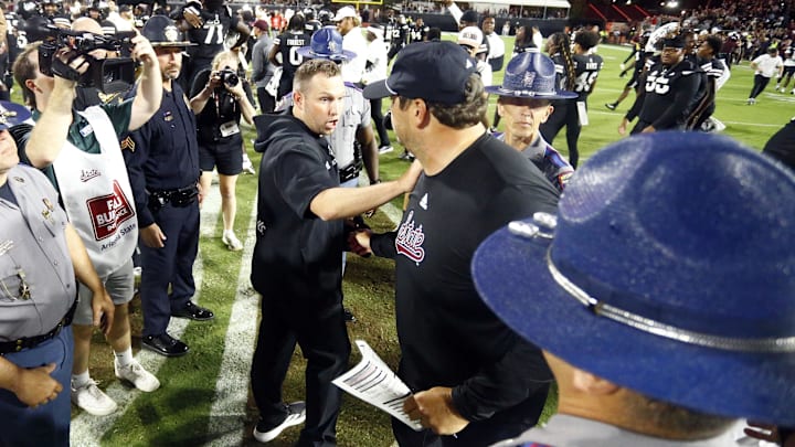 Sep 6, 2025; Starkville, Mississippi, USA; Arizona State Sun Devils head coach Kenny Dillingham (left) and Mississippi State Bulldogs head coach Jeff Lebby (right) meet at mid-field after the game at Davis Wade Stadium at Scott Field. Mandatory Credit: Petre Thomas-Imagn Images