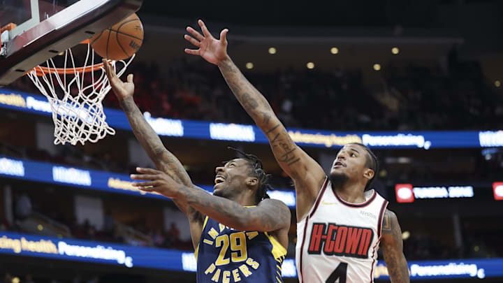 Nov 20, 2024; Houston, Texas, USA; Indiana Pacers guard Quenton Jackson (29) shoots the ball as Houston Rockets guard Jalen Green (4) defends during the third quarter at Toyota Center. Mandatory Credit: Troy Taormina-Imagn Images