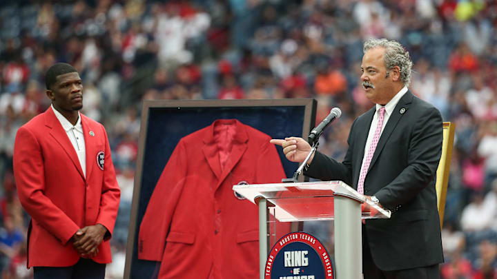 Oct 6, 2019; Houston, TX, USA; Houston Texans former player Andre Johnson (left) looks on as chairman and chief operating officer D. Cal McNair addresses the crowd after the induction of late owner Bob McNair during halftime of the game against the Atlanta Falcons at NRG Stadium. Mandatory Credit: Troy Taormina-Imagn Images