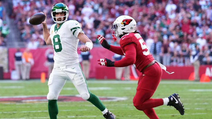 Nov 10, 2024; Glendale, Arizona, USA; New York Jets quarterback Aaron Rodgers (8) throws while being chased by Arizona Cardinals linebacker Baron Browning (53) during the first half at State Farm Stadium. Mandatory Credit: Joe Camporeale-Imagn Images
