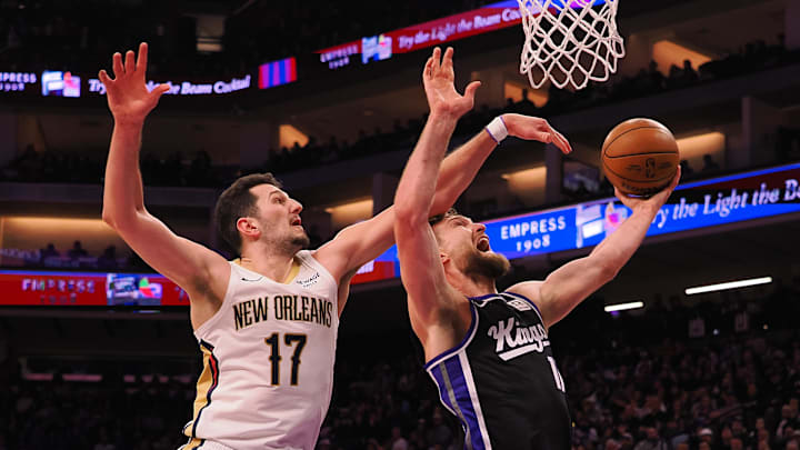 Feb 8, 2025; Sacramento, California, USA; New Orleans Pelicans forward Karlo Matkovic (17) fouls Sacramento Kings center Domantas Sabonis (11) during the second quarter at Golden 1 Center. Mandatory Credit: Kelley L Cox-Imagn Images