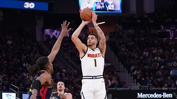 Apr 4, 2025; San Francisco, California, USA; Denver Nuggets forward Michael Porter Jr. (1) shoots over Golden State Warriors forward Kevon Looney (5) in the second period at Chase Center. Mandatory Credit: David Gonzales-Imagn Images