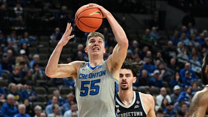 Feb 13, 2024; Omaha, Nebraska, USA;  Creighton Bluejays guard Baylor Scheierman (55) scores against Georgetown Hoyas forward Ismael Massoud (25) and guard Dontrez Styles (0) in the second half at CHI Health Center Omaha. Mandatory Credit: Steven Branscombe-Imagn Images