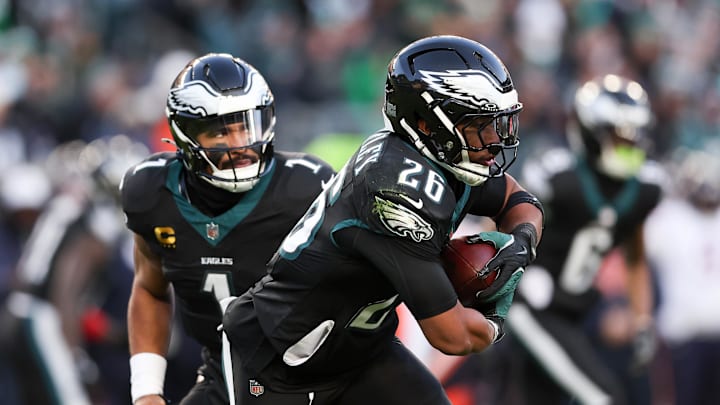 Nov 28, 2025; Philadelphia, Pennsylvania, USA; Philadelphia Eagles quarterback Jalen Hurts (1) hands the ball to Philadelphia Eagles running back Saquon Barkley (26) against the Chicago Bears during the second quarter of the game at Lincoln Financial Field. Mandatory Credit: Bill Streicher-Imagn Images