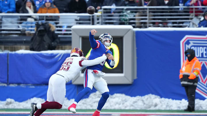 Dec 14, 2025; East Rutherford, New Jersey, USA;  Washington Commanders defensive end Jacob Martin (55) tackles New York Giants quarterback Jaxson Dart (6) during the second quarter at MetLife Stadium. Mandatory Credit: Robert Deutsch-Imagn Images