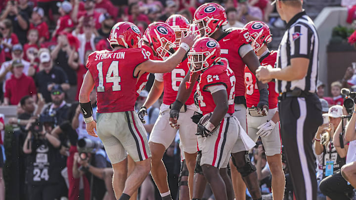 Nov 22, 2025; Athens, Georgia, USA; Georgia Bulldogs running back Bo Walker (24) reacts with quarterback Gunner Stockton (14 after scoring a touchdown against the Charlotte 49ers during the first half at Sanford Stadium. Mandatory Credit: Dale Zanine-Imagn Images