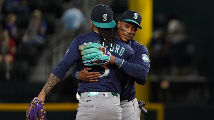 Seattle Mariners shortstop J.P. Crawford (3) and third baseman Jorge Polanco (7) hug following a game against the Texas Rangers at Globe Life Field on May 3.
