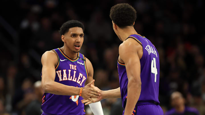 Mar 14, 2025; Phoenix, Arizona, USA; Phoenix Suns forward Ryan Dunn (0) reacts with center Oso Ighodaro (4) during the second half against the Sacramento Kings at Footprint Center. Mandatory Credit: Mark J. Rebilas-Imagn Images