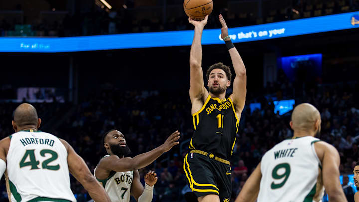 Dec 19, 2023; San Francisco, California, USA; Golden State Warriors guard Klay Thompson (11) shoots as Boston Celtics guard Jaylen Brown (7) and center Al Horford (42) and guard Derrick White (9) defend during the second half at Chase Center. Mandatory Credit: John Hefti-Imagn Images Dec 19, 2023; San Francisco, California, USA; Golden State Warriors guard Klay Thompson (11) shoots as Boston Celtics guard Jaylen Brown (7) and center Al Horford (42) and guard Derrick White (9) defend during the second half at Chase Center. Mandatory Credit: John Hefti-Imagn Images