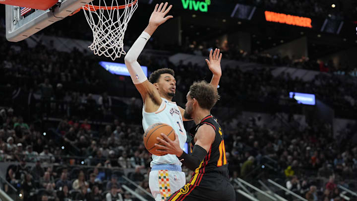 Dec 19, 2024; San Antonio, Texas, USA;  Atlanta Hawks guard Trae Young (11) goes up against San Antonio Spurs center Victor Wembanyama (1) in the second half at Frost Bank Center. Mandatory Credit: Daniel Dunn-Imagn Images
