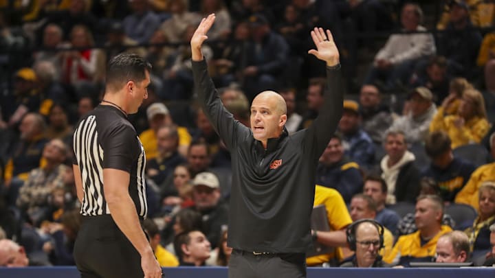 Jan 4, 2025; Morgantown, West Virginia, USA; Oklahoma State Cowboys head coach Steve Lutz argues a call during the first half against the West Virginia Mountaineers at WVU Coliseum. Mandatory Credit: Ben Queen-Imagn Images