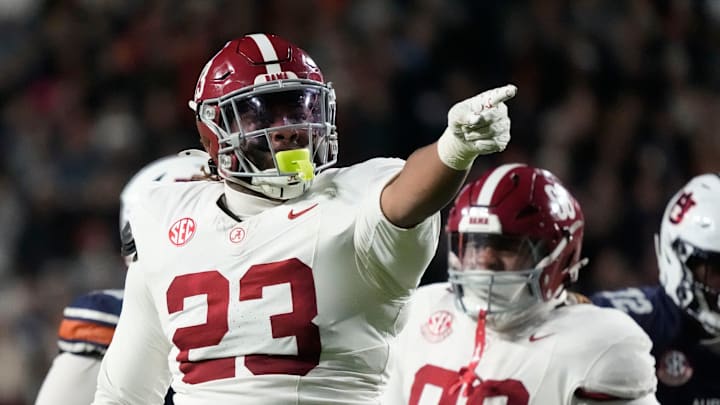 Nov 29, 2025; Auburn, Alabama, USA; Alabama defensive lineman James Smith (23) celebrates his sack of Auburn quarterback Ashton Daniels (12) at Jordan-Hare Stadium. Mandatory Credit: Gary Cosby Jr.-Tuscaloosa News