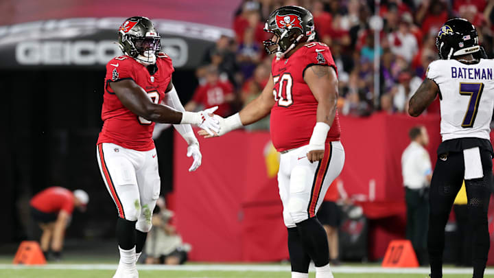 Oct 21, 2024; Tampa, Florida, USA; Tampa Bay Buccaneers linebacker Yaya Diaby (0) celebrates with defensive tackle Vita Vea (50) after sacking Baltimore Ravens quarterback Lamar Jackson (not pictured) during the first quarter at Raymond James Stadium.  