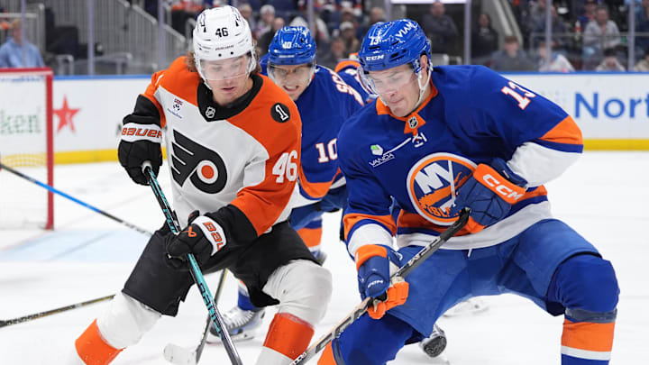Apr 3, 2026; Elmont, New York, USA;  Philadelphia Flyers forward Trevor Zegras (46) and New York Islanders fordward Mathew Barzal (13) battle for a puck during the third period at UBS Arena. Mandatory Credit: Alexander Wohl-Imagn Images