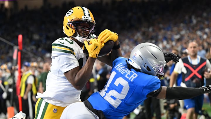 Nov 27, 2025; Detroit, Michigan, USA; Green Bay Packers wide receiver Dontayvion Wicks (13) catches a pass for a touchdown against Detroit Lions safety Thomas Harper (12) during the second quarter at Ford Field. Mandatory Credit: Lon Horwedel-Imagn Images Nov 27, 2025; Detroit, Michigan, USA; Green Bay Packers wide receiver Dontayvion Wicks (13) catches a pass for a touchdown against Detroit Lions safety Thomas Harper (12) during the second quarter at Ford Field. Mandatory Credit: Lon Horwedel-Imagn Images