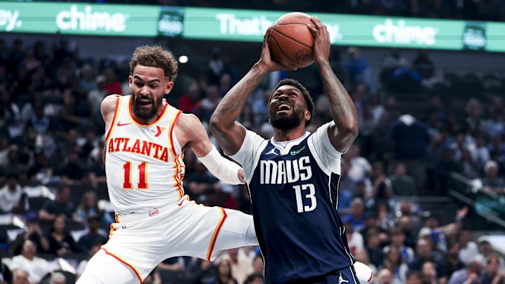 Apr 2, 2025; Dallas, Texas, USA;  Dallas Mavericks forward Naji Marshall (13) shoots past Atlanta Hawks guard Trae Young (11) during the first quarter at American Airlines Center. Mandatory Credit: Kevin Jairaj-Imagn Images