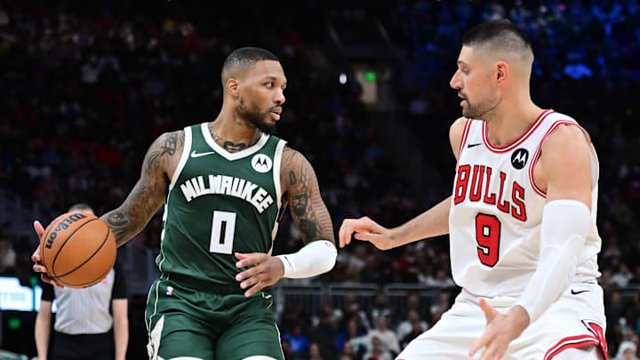 Nov 20, 2024; Milwaukee, Wisconsin, USA; Milwaukee Bucks guard Damian Lillard (0) drives against Chicago Bulls center Nikola Vucevic (9) in the fourth quarter at Fiserv Forum. Mandatory Credit: Benny Sieu-Imagn Images Nov 20, 2024; Milwaukee, Wisconsin, USA; Milwaukee Bucks guard Damian Lillard (0) drives against Chicago Bulls center Nikola Vucevic (9) in the fourth quarter at Fiserv Forum. Mandatory Credit: Benny Sieu-Imagn Images