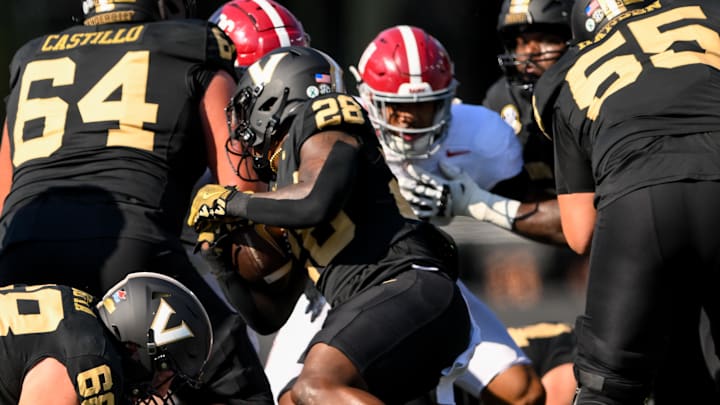 Vanderbilt Commodores running back Sedrick Alexander (28) gets tackled by Alabama Crimson Tide defensive lineman Jeremiah Beaman (92)