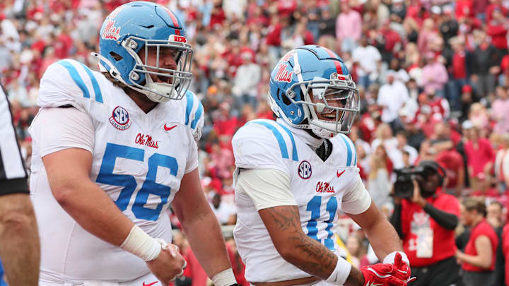 Nov 2, 2024; Fayetteville, Arkansas, USA; Ole Miss Rebels wide receiver Jordan Watkins (11) celebrates with offensive lineman Reece McIntyre (56) after catching a pass for a touchdown in the second quarter against the Arkansas Razorbacks at Donald W. Reynolds Razorback Stadium. Mandatory Credit: Nelson Chenault-Imagn Images