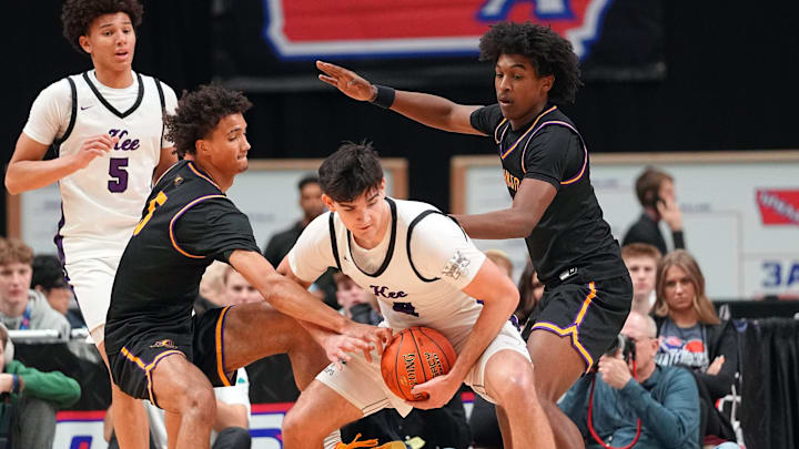 Evan Jacobson of Waukee drives to the basket as Joshua Jenkins of Johnston defends during a semifinal game of the Iowa high school boys state basketball tournament at the Casey's Center in Des Moines, March 12, 2026.
